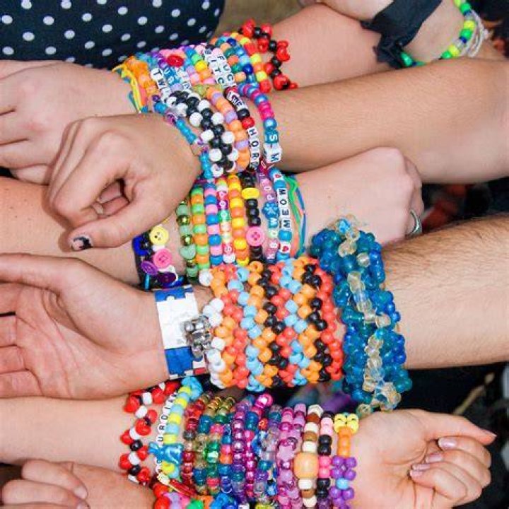 A stack of friendship bracelets with colorful beads and beads that spell "Eclipse 24"