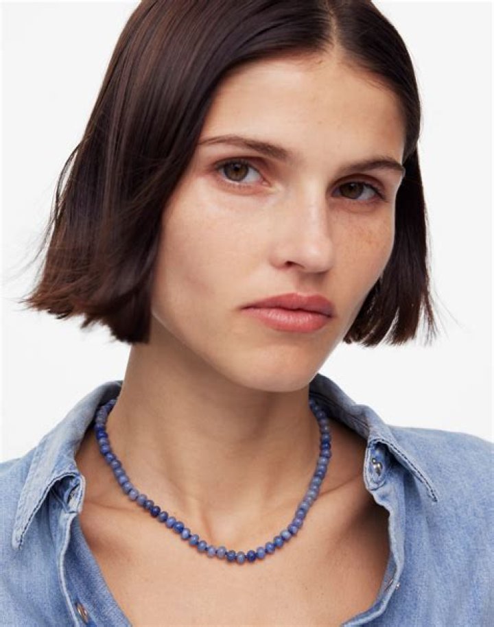 A Target beaded choker necklace with a metal bow accent