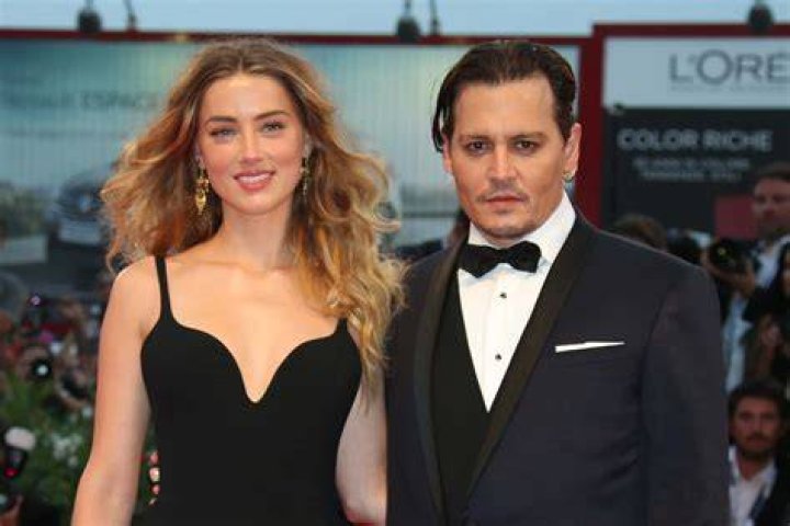 Amber Heard smiling with Johnny Depp