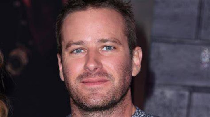 Armie Hammer half smiling at event