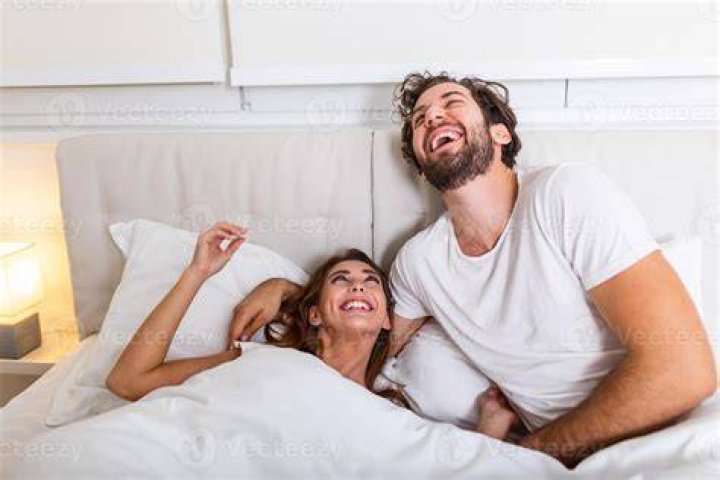 Couple laughing in bed