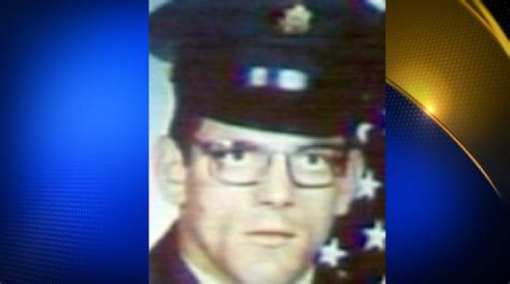 Gary Mathias. Man with glasses posing for a picture in an army uniform.