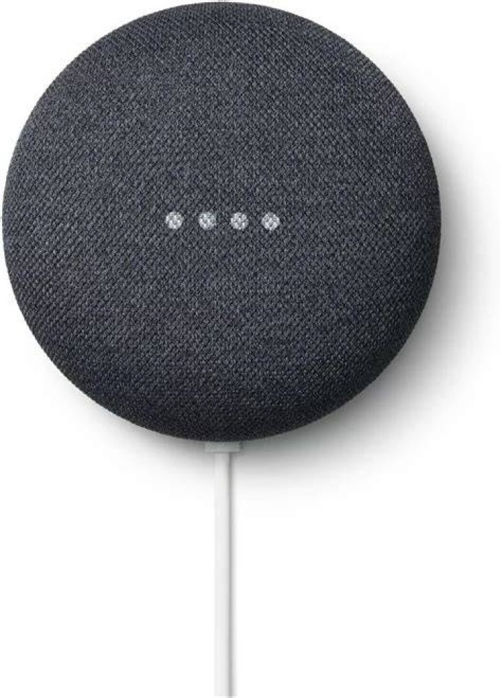 Google Nest Audio in black on nightstand next to bed