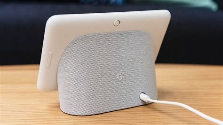 Google Nest Audio on top of coffeetable with a book and pair of Google socks
