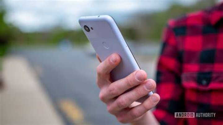 Google Pixel 3a Purple-ish Holding Phone Close