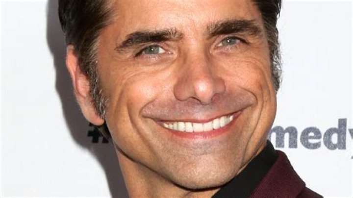 John Stamos grinning