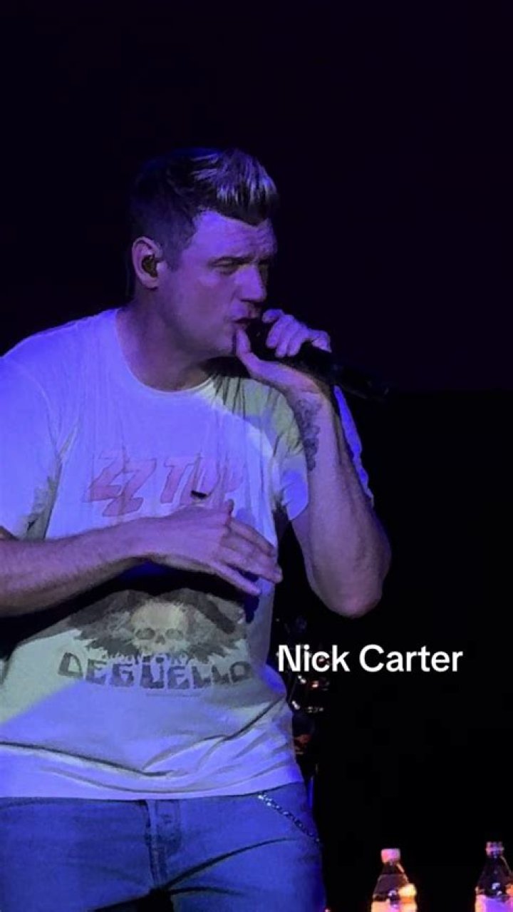 Nick Carter singing onstage with the rest of the Backstreet Boys.