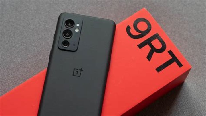 OnePlus 9RT showing back of the phone on a box OnePlus 9RT showing back of the phone on a box