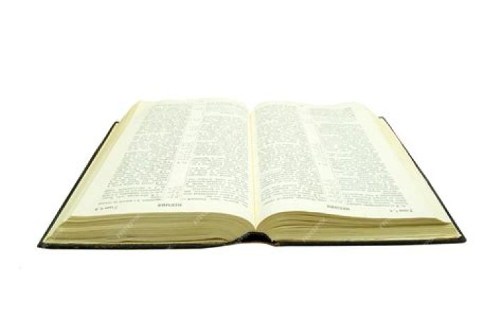 Opened bible held in the hand Opened bible held in the hand