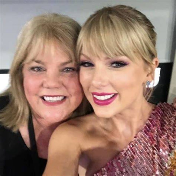 Taylor Swift with her mom, Travis Kelce with his mom