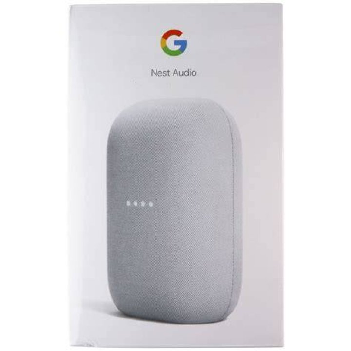 The Google Nest Audio speaker in gray pictured in front of plants on a table