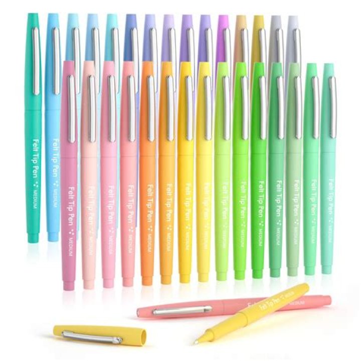 Three pastel pens, next to two pastel pen boxes