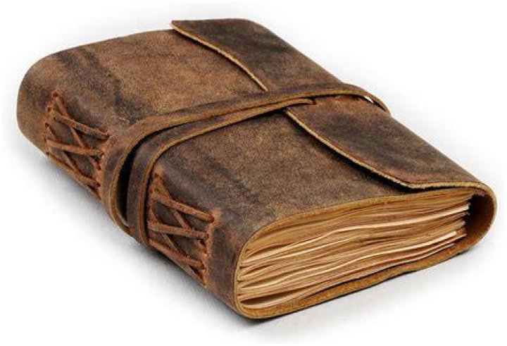 Two black leather journals decorated with gold suns, moons, and stars surrounded by plants and pens